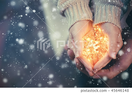 Close view of a couple holding warm Christmas lights 45646148