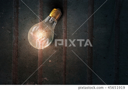 Light bulb on wooden surface 45651919