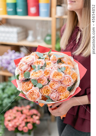 European floral shop. Bouquet of beautiful Mixed flowers in woman hand. Excellent garden flowers in European floral shop. Bouquet of beautiful Mixed flowers in woman hand. Excellent garden flowers in 45654852