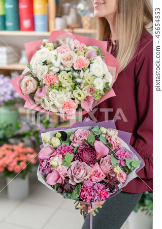European floral shop. Two Bouquet of beautiful Mixed flowers in woman hand. Excellent garden flowers European floral shop. Two Bouquet of beautiful Mixed flowers in woman hand. Excellent garden flowers 45654853