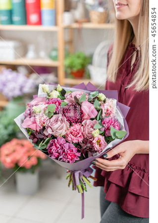 European floral shop. Two Bouquet of beautiful Mixed flowers in woman hand. Excellent garden flowers European floral shop. Two Bouquet of beautiful Mixed flowers in woman hand. Excellent garden flowers 45654854