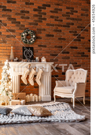 Loft apartments, brick wall with candles and Christmas tree wreath. White wool socks for Santa on 45654926