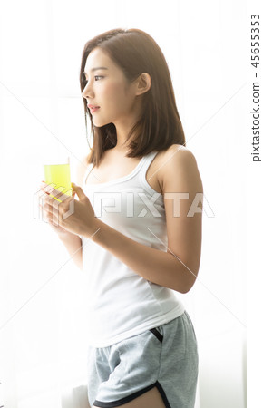 Asian Young woman relaxing at cozy home happy Asian Young woman relaxing at cozy home happy 45655353