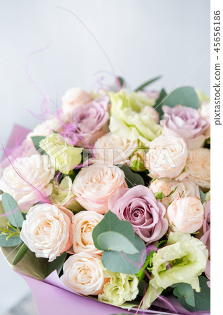 Bouquet of fresh spring flowers on gray wall background. Floral bunch in glass vase. flower shop 45656186