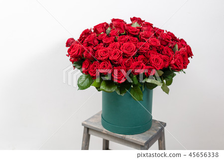 Big luxury bright bouquet on wooden table. One hundred of garden red roses. Color passionately 45656338