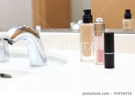 Foundation and lipstick placed in the wash basin Foundation and lipstick placed in the wash basin 45656458