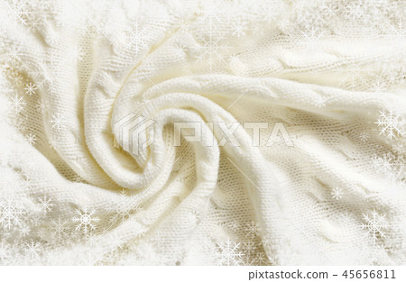 Folded white knitted plaid and snowflakes frame Folded white knitted plaid and snowflakes frame 45656811