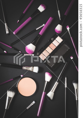 The makeup products. Brush and eyeshadow powder. 45658315