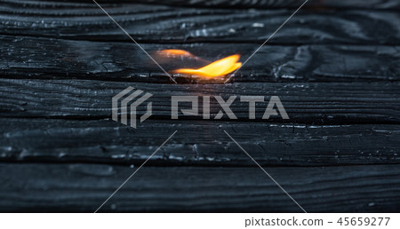 Charred wooden planks and fire. Background, texture. Please. 45659277