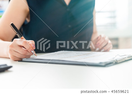 Women's hands fill out a questionnaire. Women's hands fill out a questionnaire. 45659621