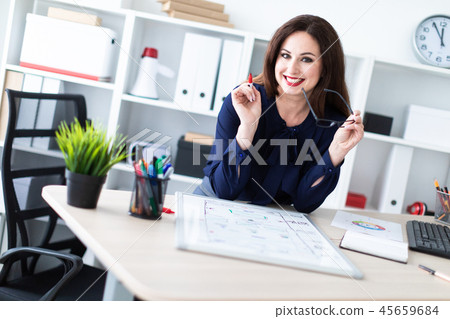 A young girl standing at a computer table and working with a magnetic Board. 45659684