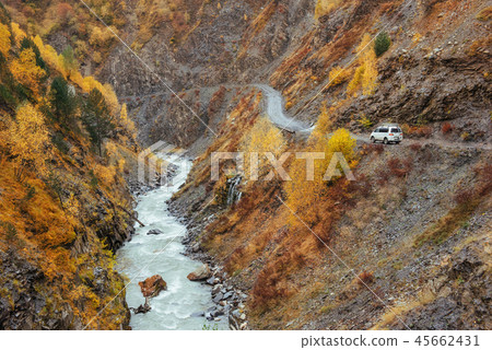 golden autumn landscape between rocky mountains and noisy river in Georgia. Europe golden autumn landscape between rocky mountains and noisy river in Georgia. Europe 45662431