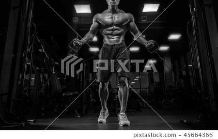handsome man with big muscles trains in the gym, e handsome man with big muscles trains in the gym, e 45664366