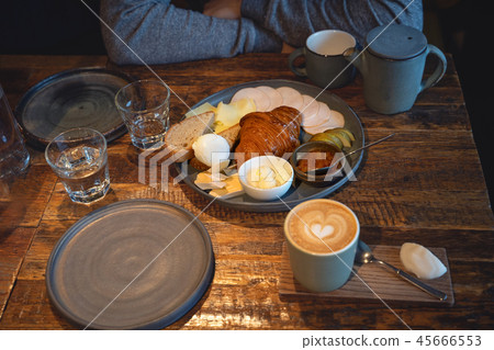 Top view on breakfast with cup of coffee and toast with cheese served on wooden table 45666553