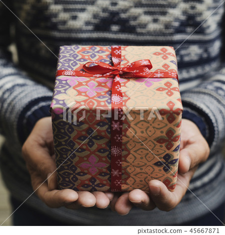 young man with a christmas gift 45667871