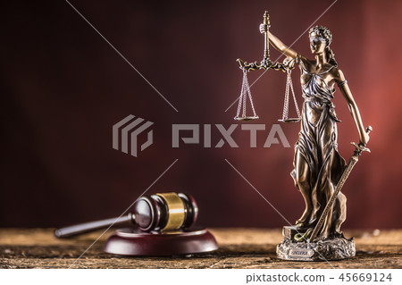 Lady Justicia holding sword and scale on table. 45669124