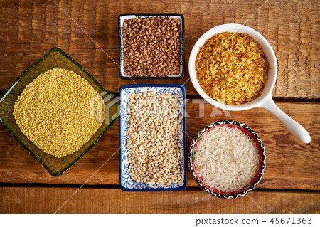top view of several types of porridge in different bowls on an wooden table top view of several types of porridge in different bowls on an wooden table 45671363