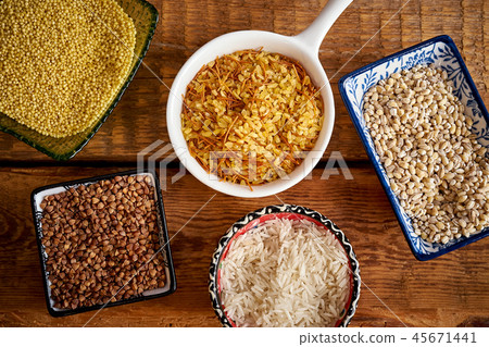 top view of several types of porridge in different bowls on an wooden table 45671441