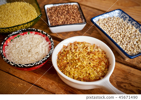 top view of several types of porridge in different bowls on an wooden table 45671490