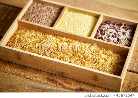 different, colorful types of groats in a wooden box 45671544