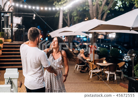 Young couple having fun at the summer restaurant. 45672555