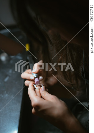 girl master processes the metal plate in the home workshop girl master processes the metal plate in the home workshop 45672713