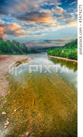 stream of water in the rocks with sky and mirror stream of water in the rocks with sky and mirror 45674275