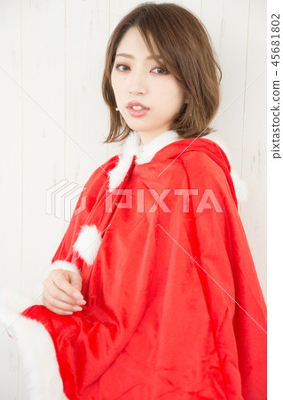 Woman wearing a santa cape 45681802