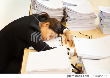 Exhausted woman have lot of work with documents fall asleep on working desk. 45685565