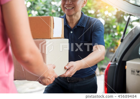 Woman receiving parcel cardboard box from delivery man Carrying 45689484