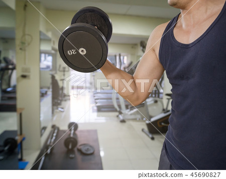 Man training in the gym - dumbbell biceps curl Man training in the gym - dumbbell biceps curl 45690827
