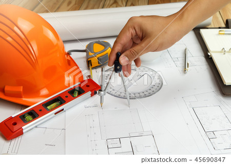 An architect or engineer working on blueprint An architect or engineer working on blueprint 45690847