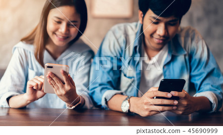 Friends using smartphone on cafe. 45690999