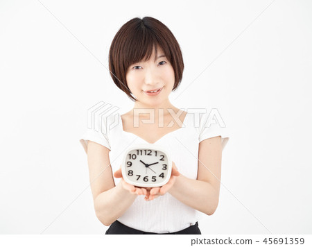 Woman putting a clock on the palm with white background 45691359
