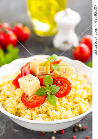 Millet porridge with tomatoes and cheese Millet porridge with tomatoes and cheese 45692007