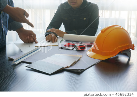 architect and engineer discussing on working table architect and engineer discussing on working table 45692334