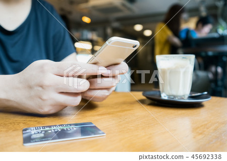 woman using smartphone for mobile transaction woman using smartphone for mobile transaction 45692338