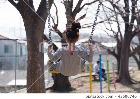 Child over the swing (child with cochlear implant) 45696740