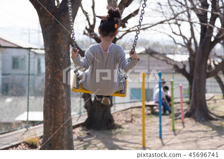 Child over the swing (child with cochlear implant) Child over the swing (child with cochlear implant) 45696741