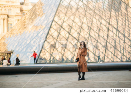 Attractive girl spend time in city. Beautiful girl model in Paris Attractive girl spend time in city. Beautiful girl model in Paris 45699084