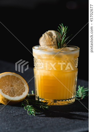 Cold Whiskey Sour Cocktail with ice and apple chips, piece of thyme on top Cold Whiskey Sour Cocktail with ice and apple chips, piece of thyme on top 45702677