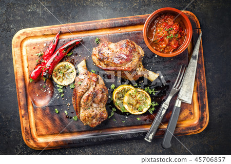 Two Barbecue Leg of Lamb as top view on old rusty Two Barbecue Leg of Lamb as top view on old rusty 45706857