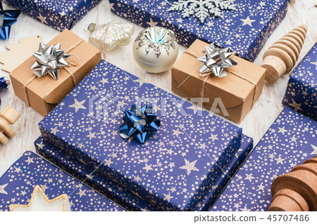 Presents in blue wrapping paper on table 45707486