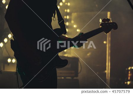 Electric bass guitar player on the stage Electric bass guitar player on the stage 45707579