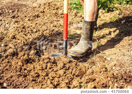 Detail on old man foot in dirty black rubber boots Detail on old man foot in dirty black rubber boots 45708068