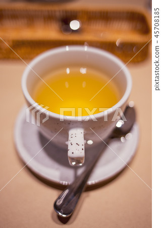 Cup of green tea with spoon in the restaurant Cup of green tea with spoon in the restaurant 45708185