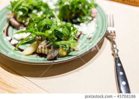 Plate of fresh salad served on table in restaurant 45708186