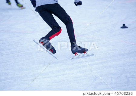 Short track sportsman skating on ice rink 45708226