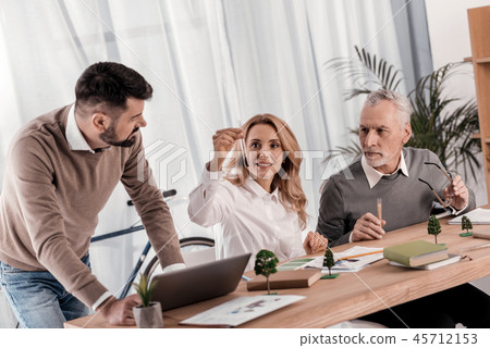Happy female ecologist holding a beaker 45712153