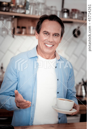Pleasant delighted barista smiling to you Pleasant delighted barista smiling to you 45714261